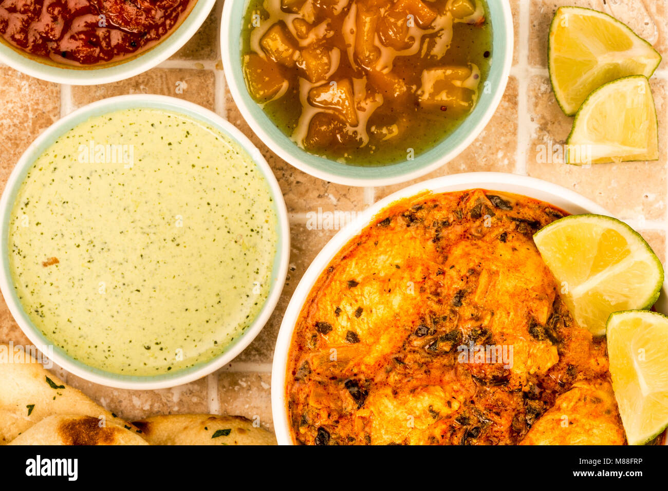 Indian Style Chicken Saag Masala Curry On A Tiled Kitchen Table Top