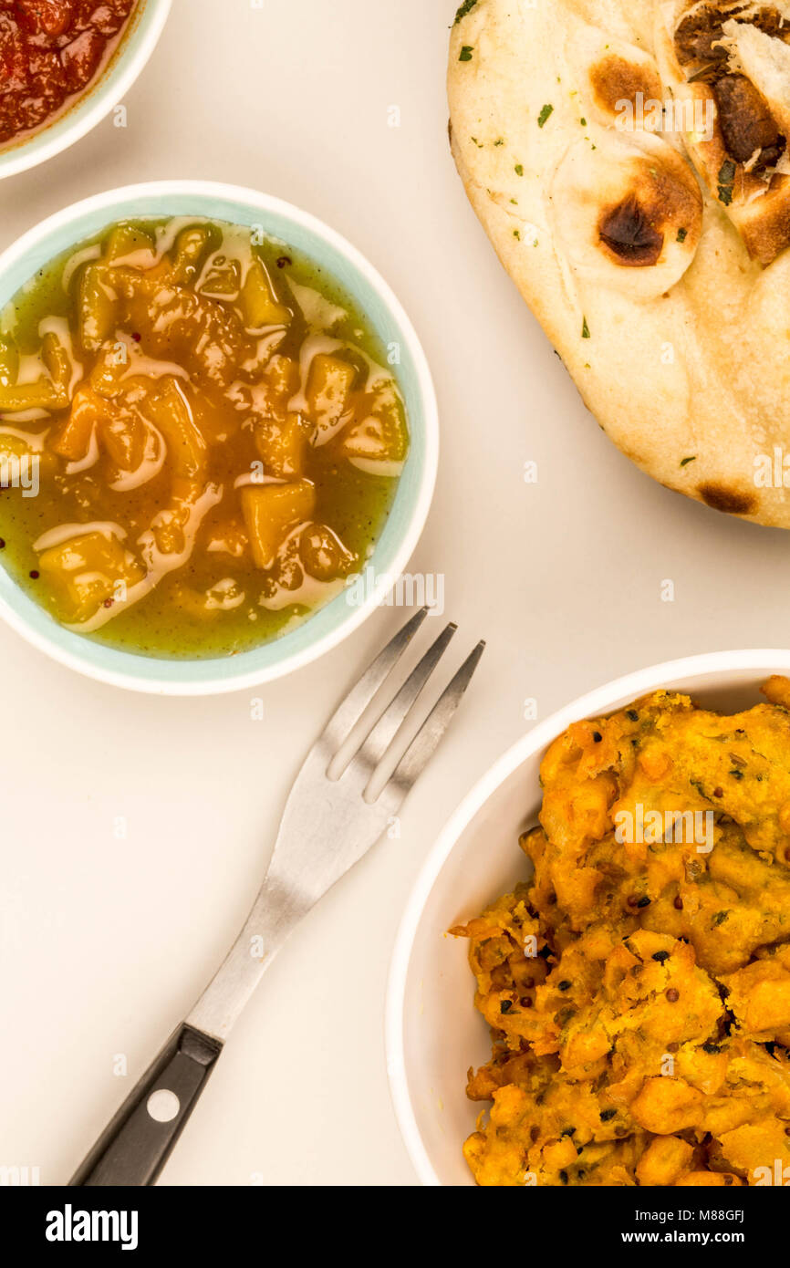 Indian Style Snack Of Fried Onion Bhajis Against A Grey Background With