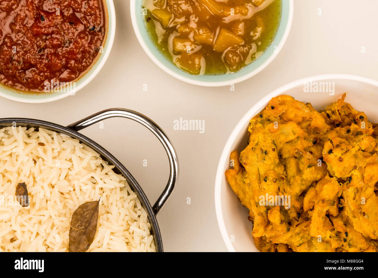 Indian Style Snack Of Fried Onion Bhajis Against A Grey Background With