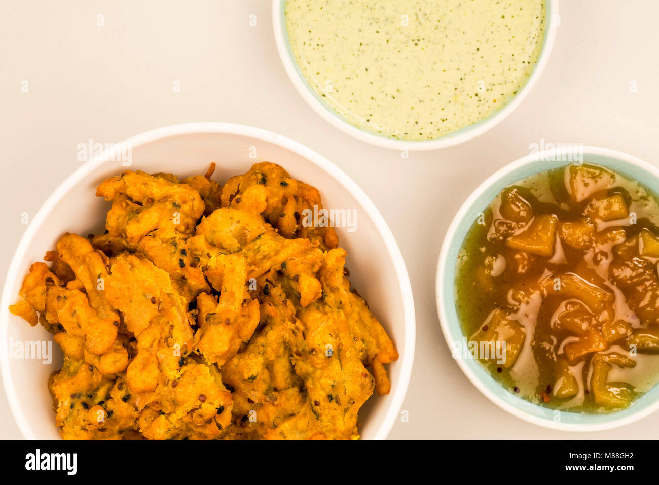 Indian Style Snack Of Fried Onion Bhajis Against A Grey Background With