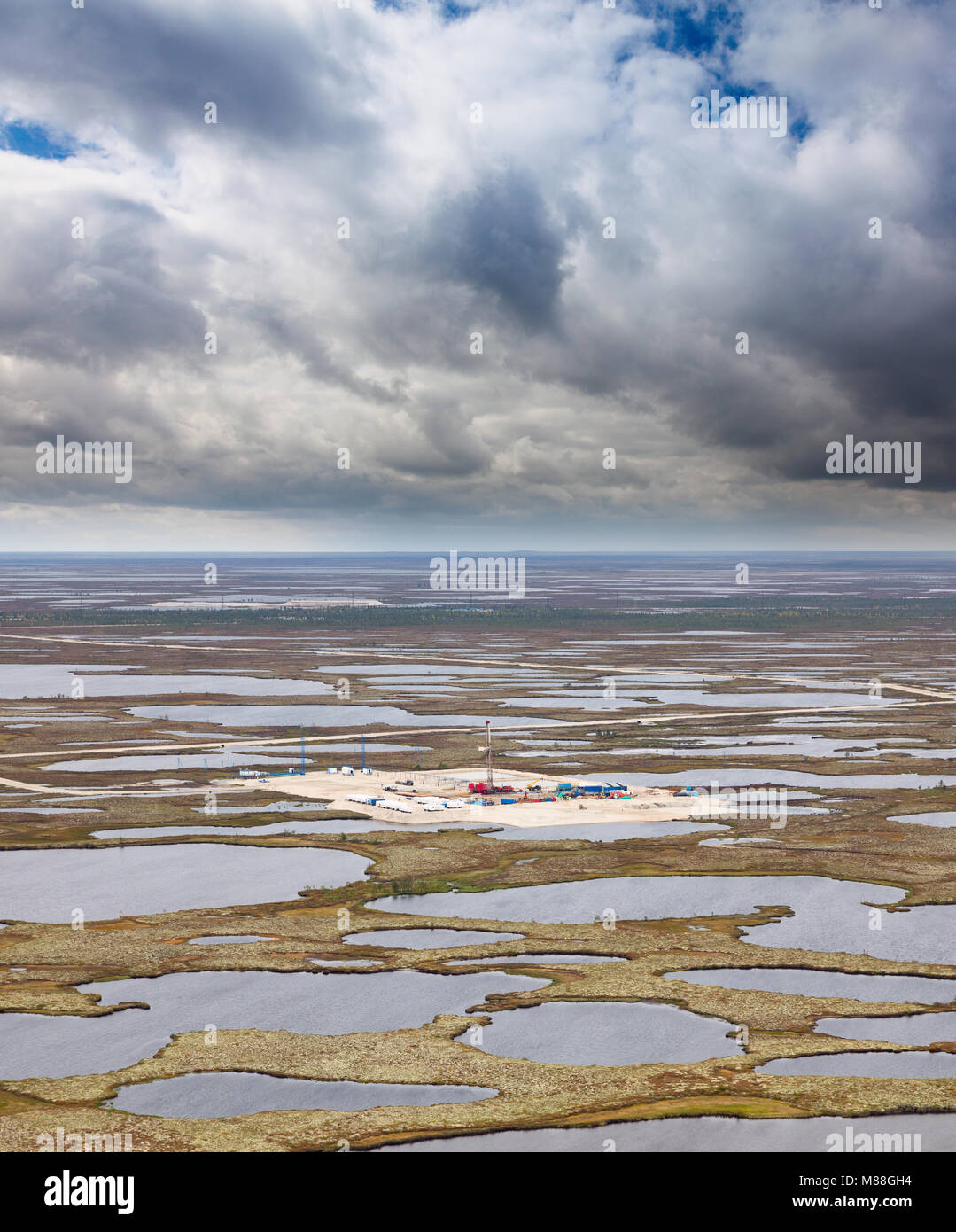 Aerial view of oilfield on impassable swamp area. Stock Photo