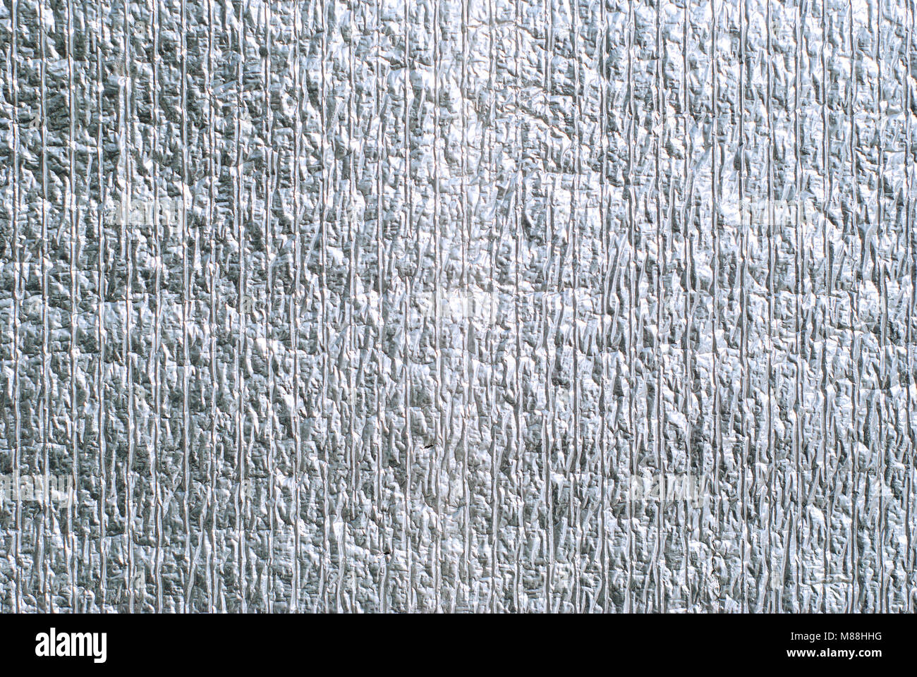 background, texture - silvery wrinkled surface of thermal insulating foil Stock Photo