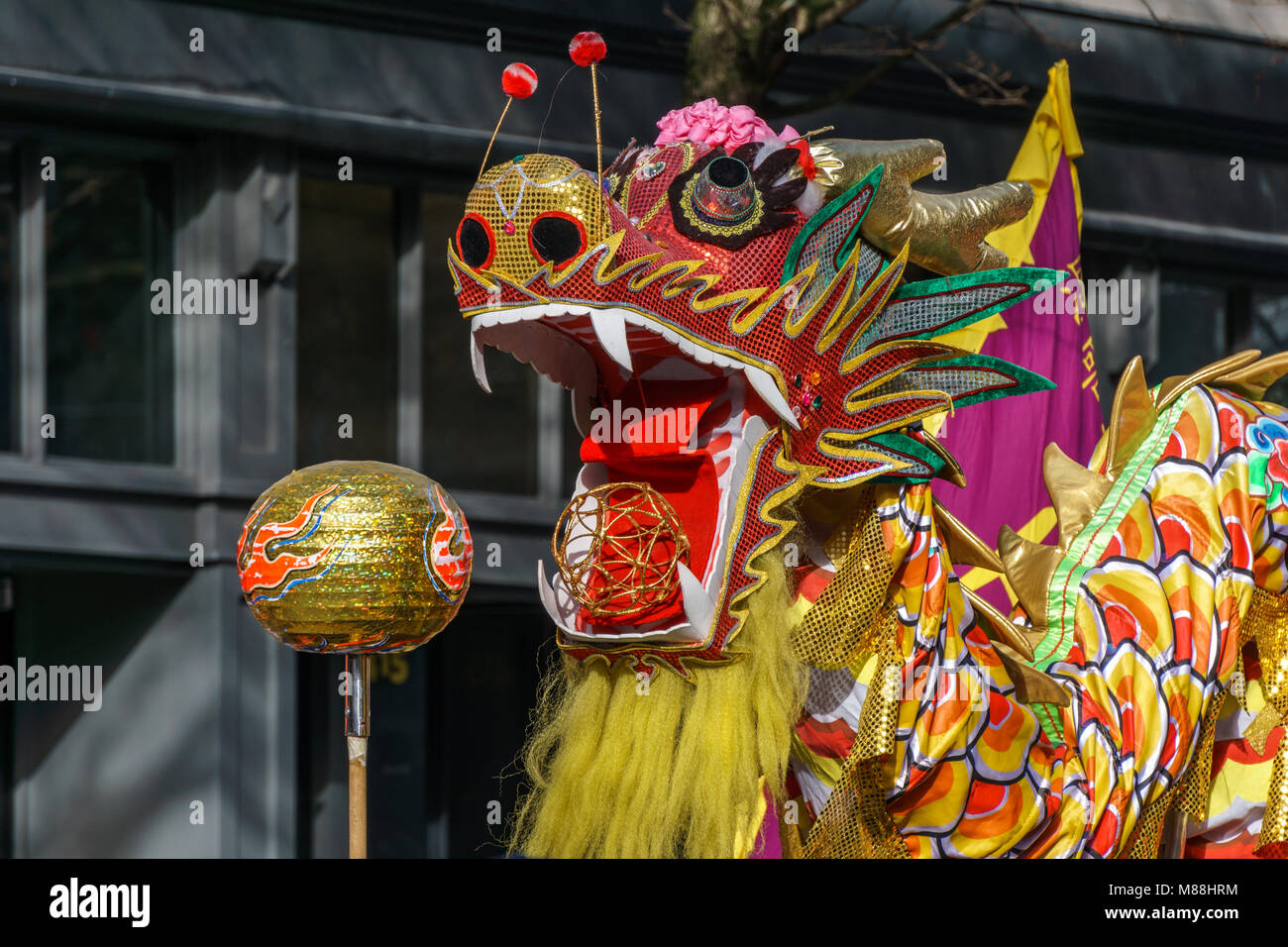 VANCOUVER, CANADA - February 18, 2018: People playing dragon dance for Chinese New Year in Chinatown. Stock Photo