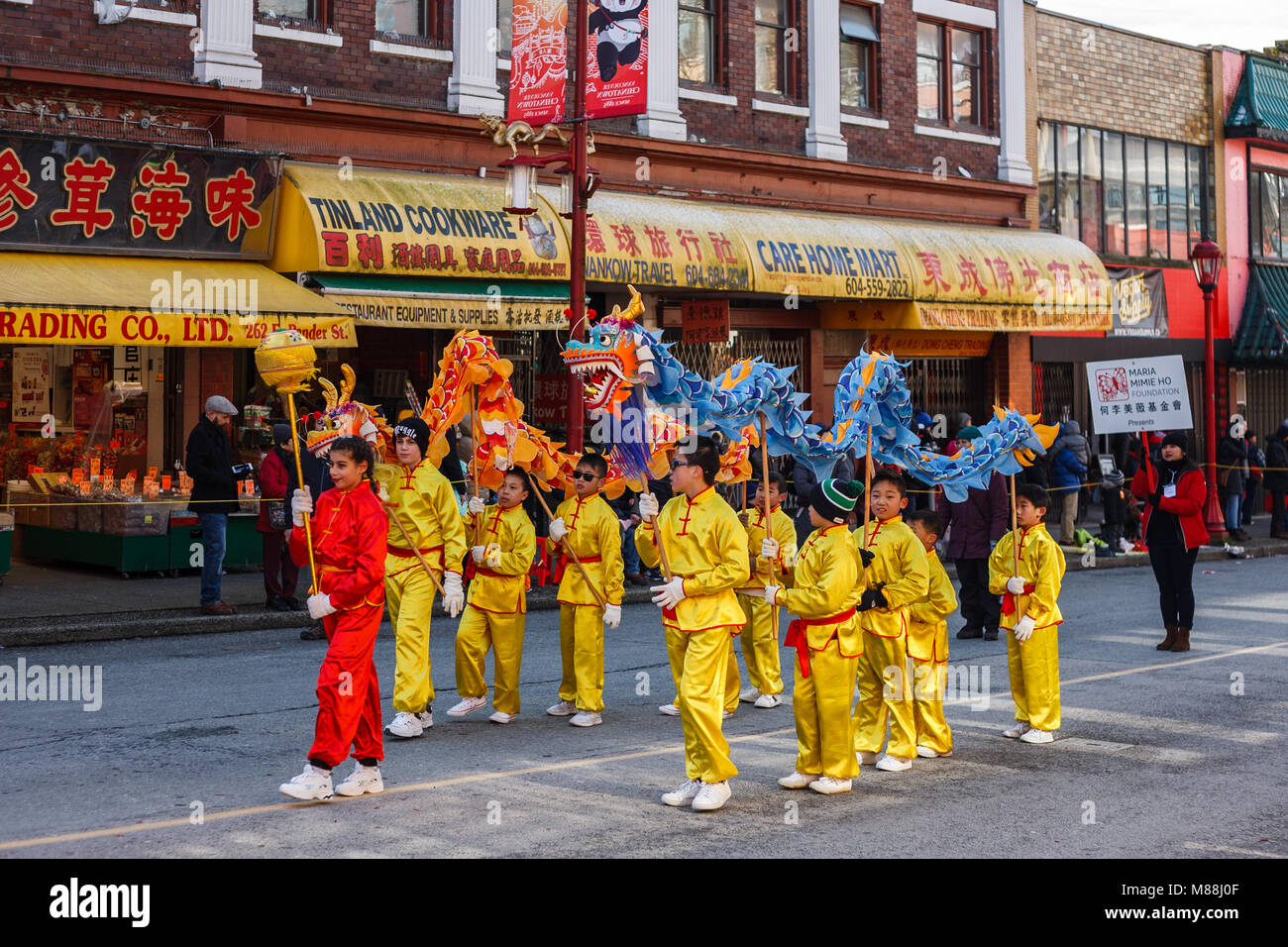 VANCOUVER, CANADA - February 18, 2018: People playing dragon dance for Chinese New Year in Chinatown. Stock Photo