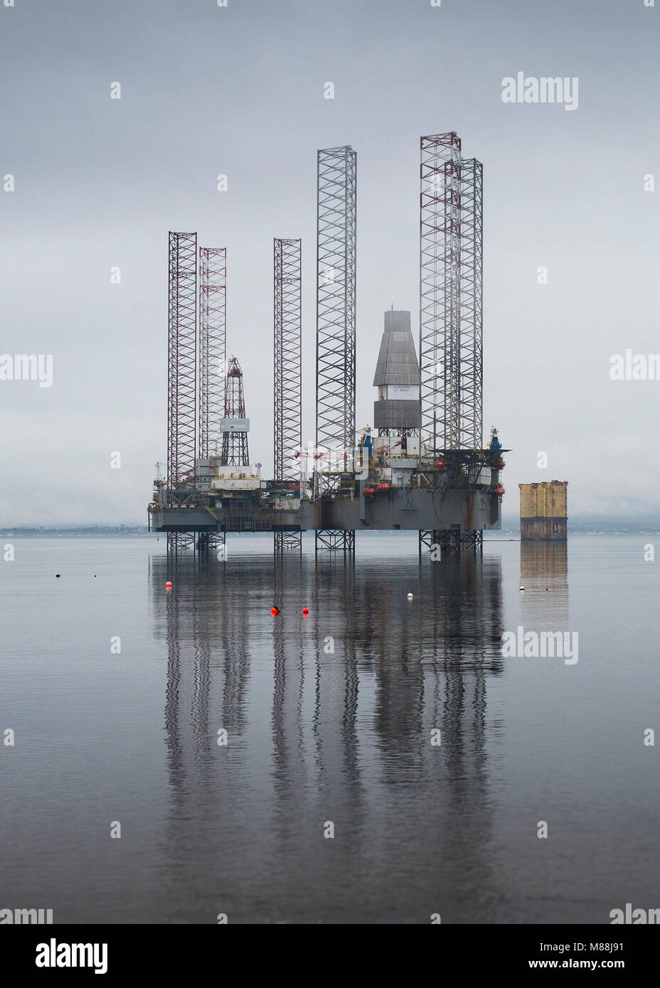 Oil rigs drilling platforms moored in Cromarty Firth viewed from town of Cromarty on the Black Isle in Ross & Cromarty, Highland Region, Scotland Stock Photo