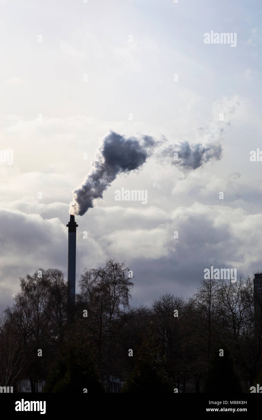 Thick smoke coming from an industrial chimney Stock Photo