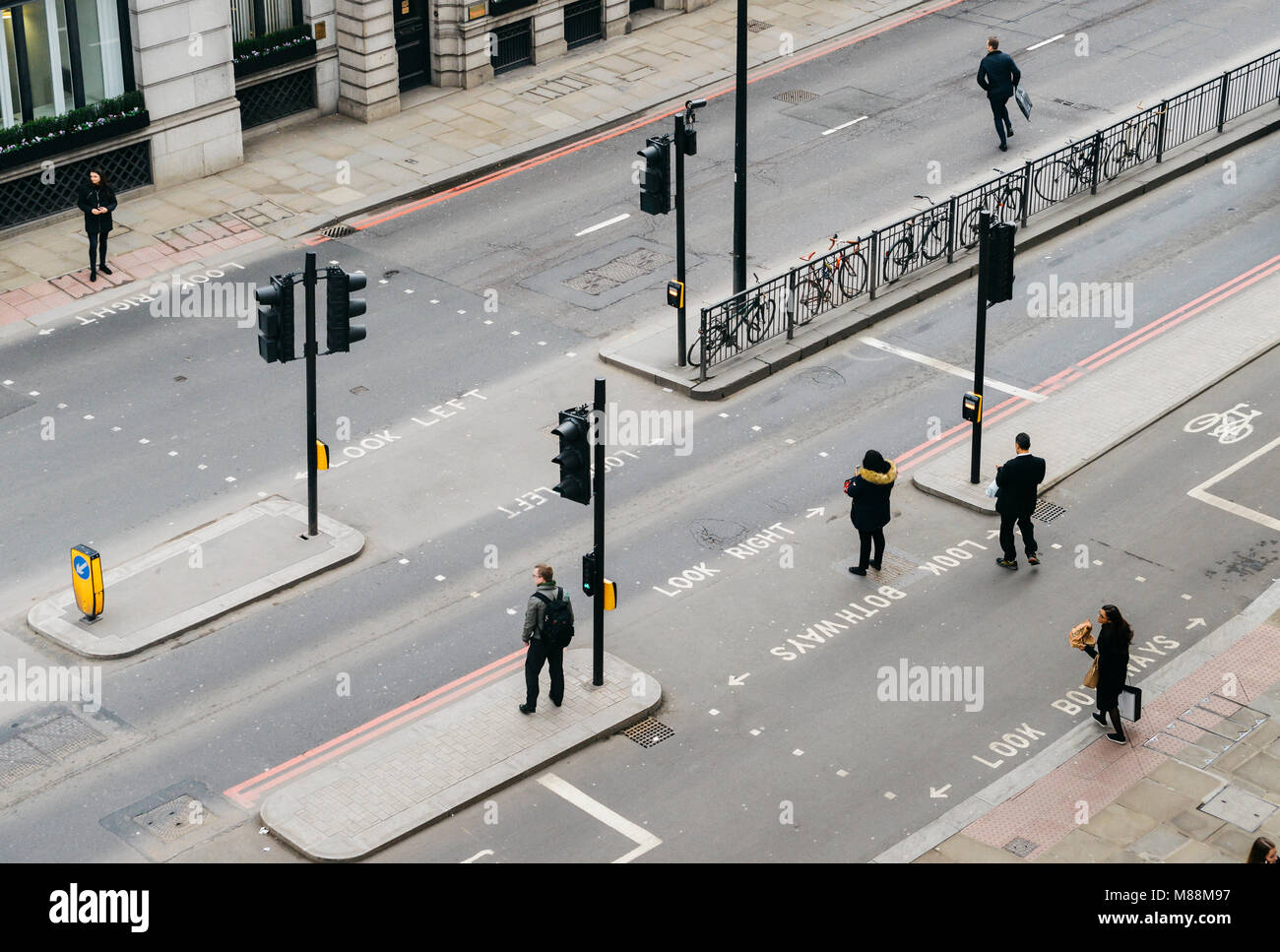 London, United Kingdom- March 13, 2018: High perspective view of officer worker pedestrians in the City of London crossing the street Stock Photo
