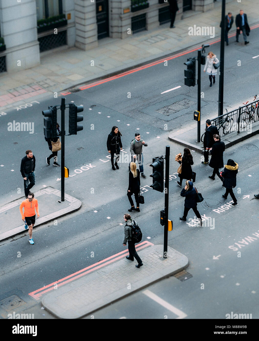 London, United Kingdom- March 13, 2018: High perspective view of officer worker pedestrians in the City of London crossing the street Stock Photo
