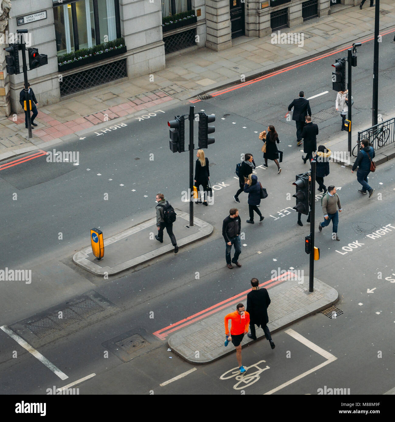 London, United Kingdom- March 13, 2018: High perspective view of officer worker pedestrians in the City of London crossing the street Stock Photo