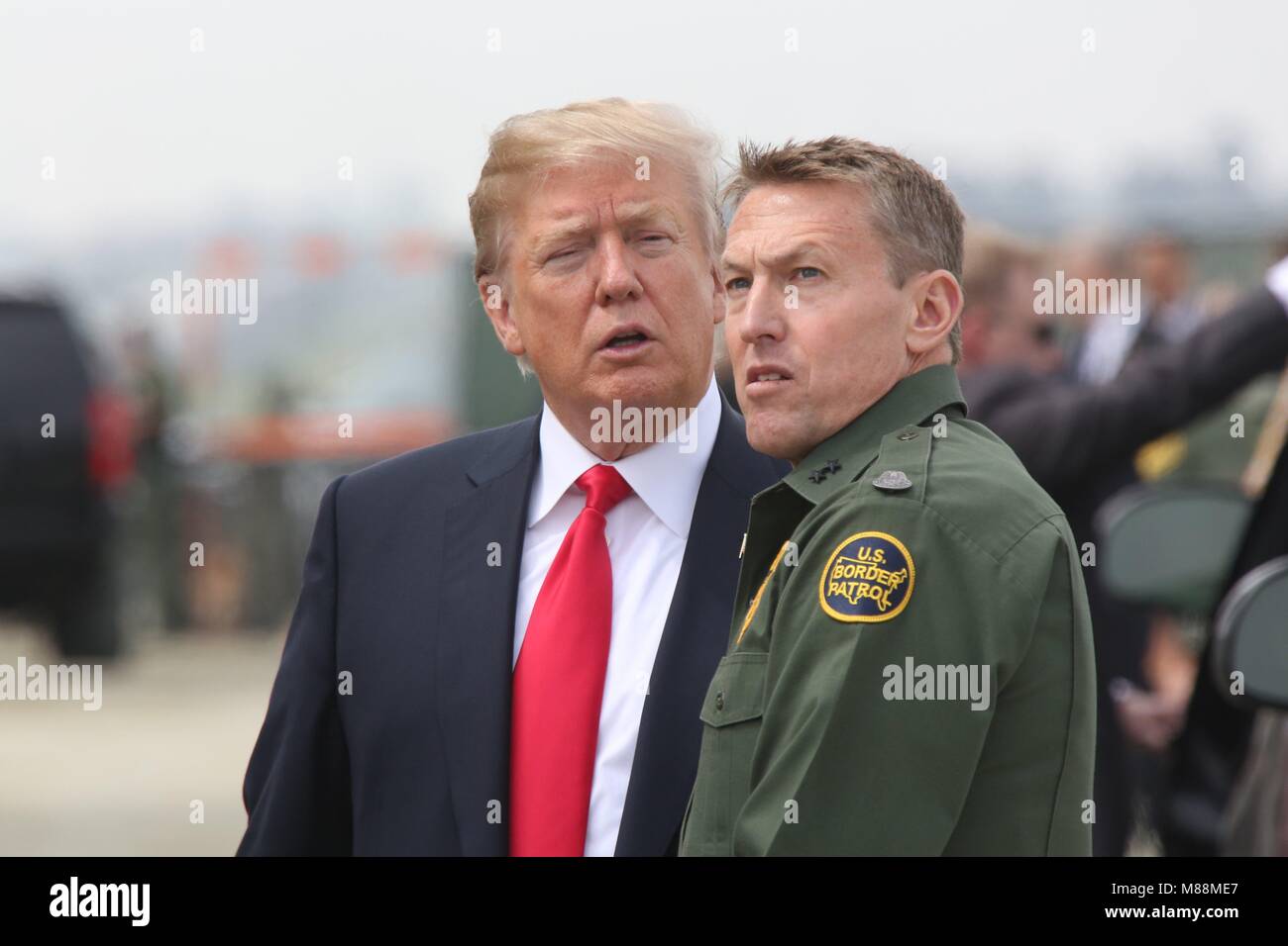 U.S President Donald Trump chats with Border Patrol Sector Chief Rodney Scott, while viewing prototypes of the proposed border wall at the Otay Mesa Port of Entry March 13, 2018 in San Diego, California. Stock Photo