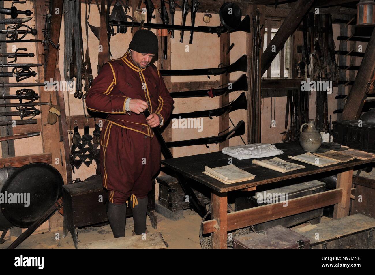 Colonist loading his musket at the Jamestown Settlement, Virginia Stock Photo