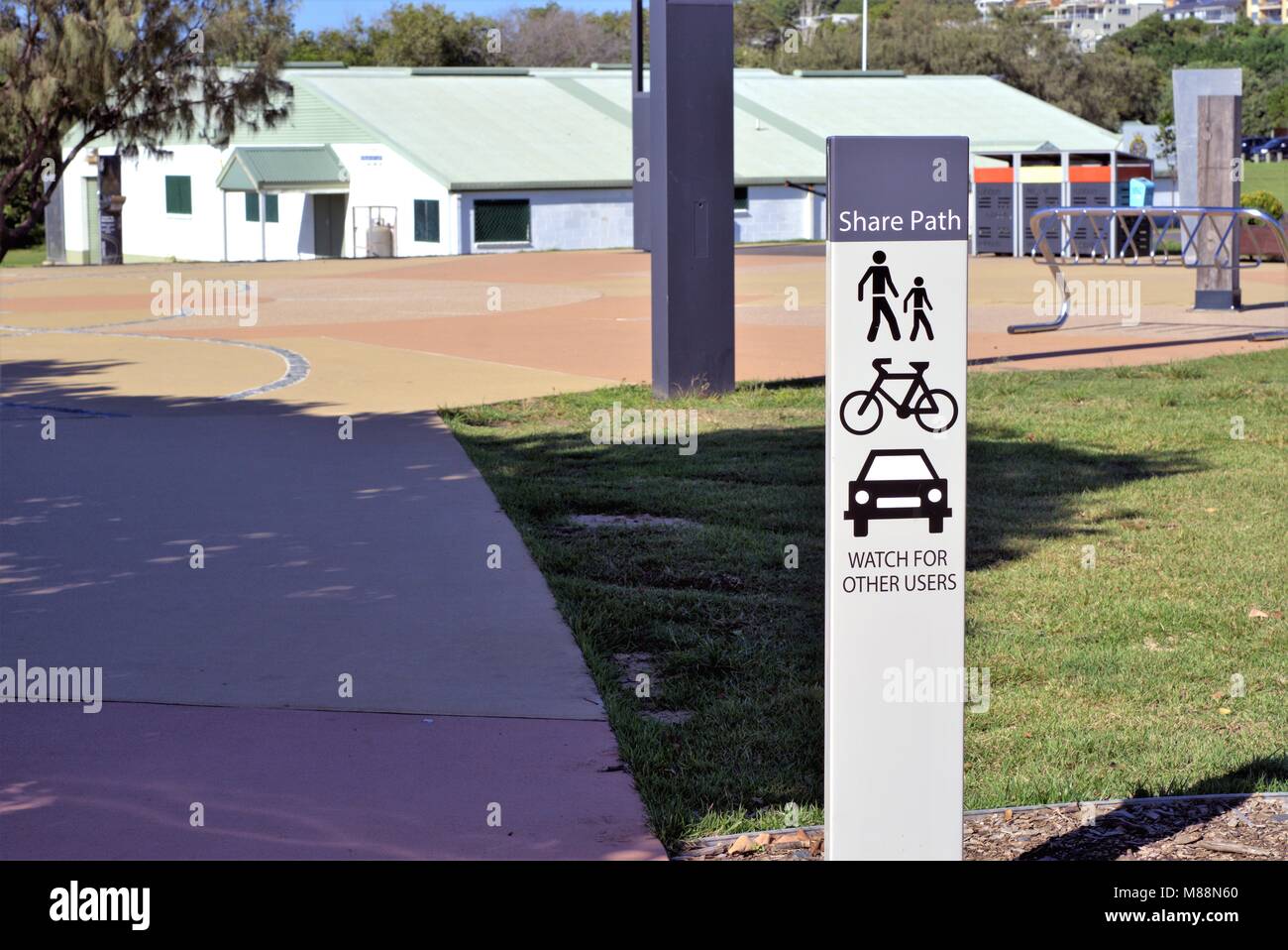 Public information sign post says 'Share Path, Watch for Other Users' at park in Australia. Stock Photo