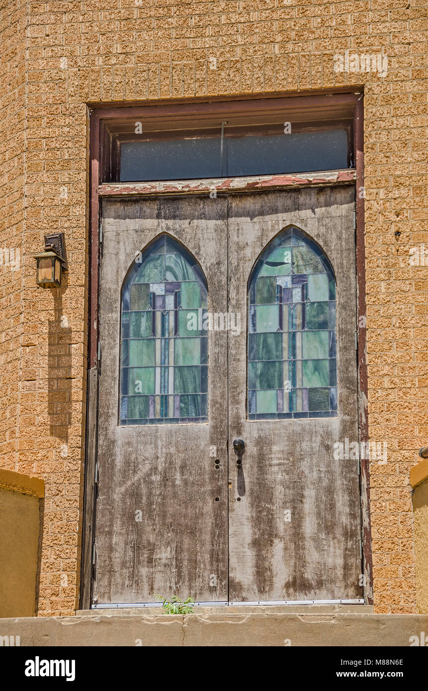 Front Doors To A Church Made Of Bricks With Two Stained Glass