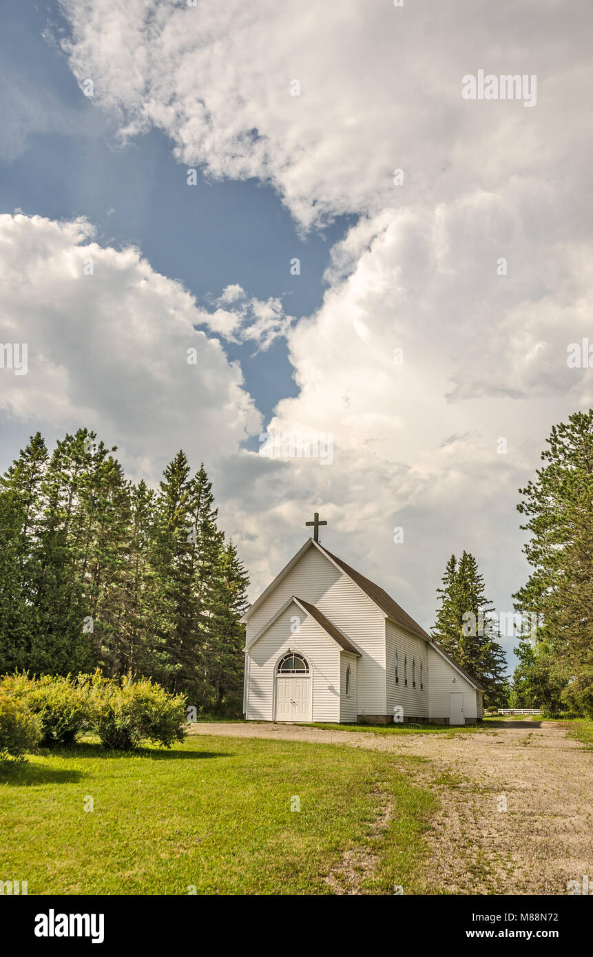 Amazing clouds behind a white 19th century rural church Stock Photo
