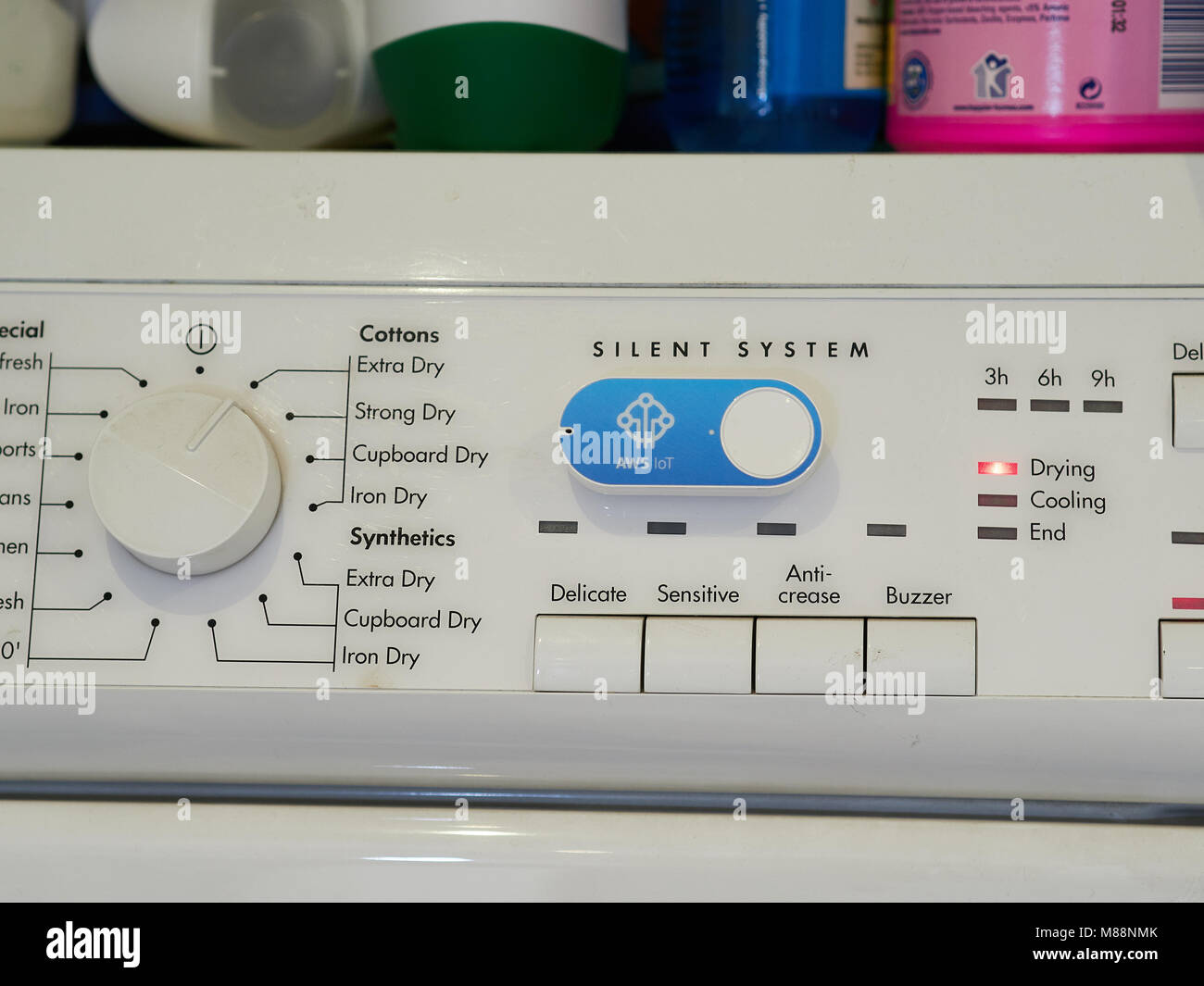 Amazon AWS Dash button - connected IoT device for automatic tasks or  purchases. Shown on washer dryer in a home kitchen Stock Photo - Alamy