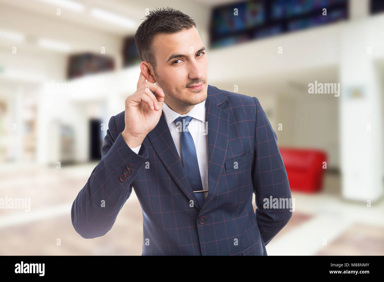 Friendly interested realtor or real estate agent sales man leaning and