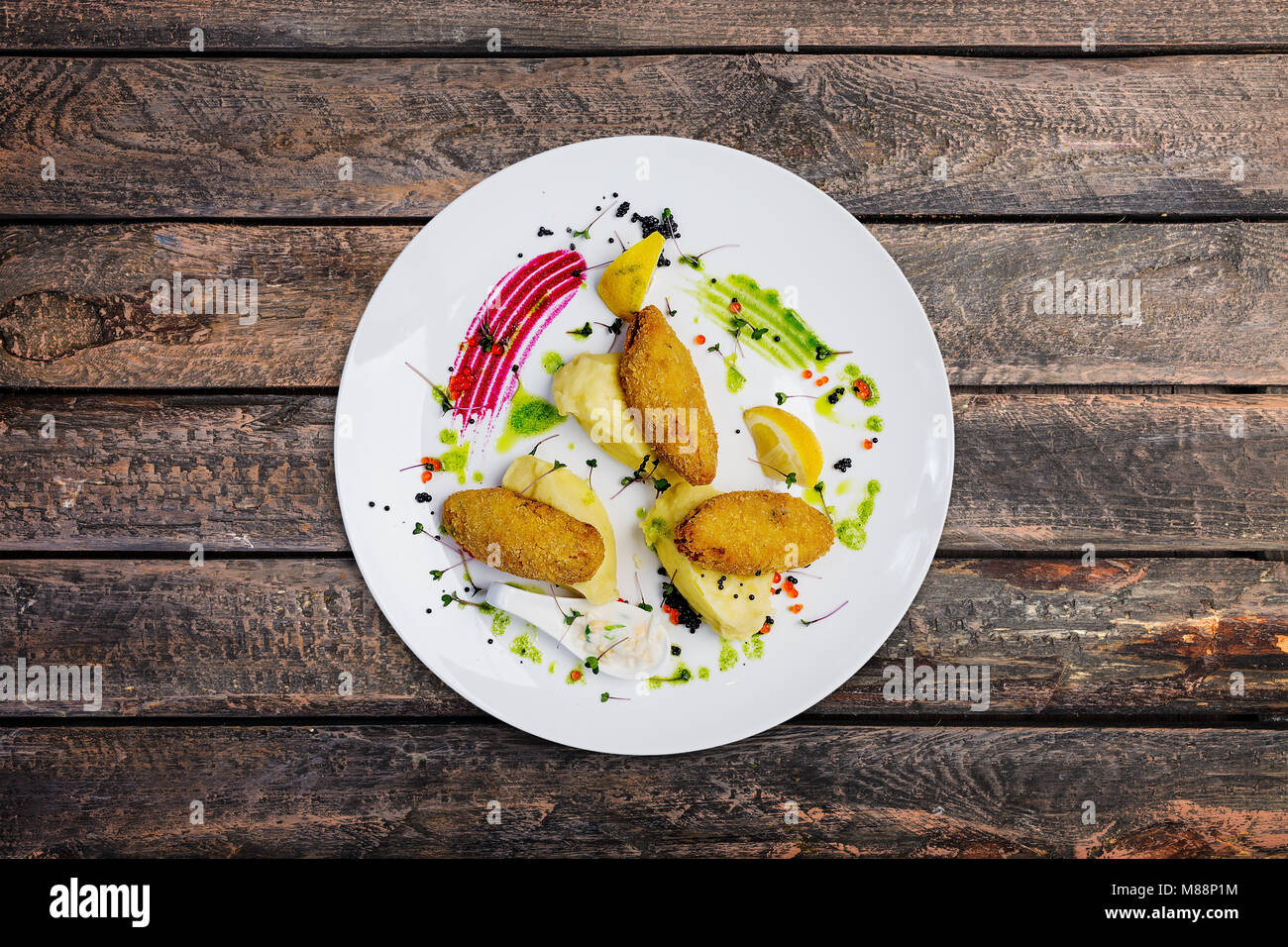Fish cutlets stuffed with quail eggs with mashed potatoes. Stock Photo