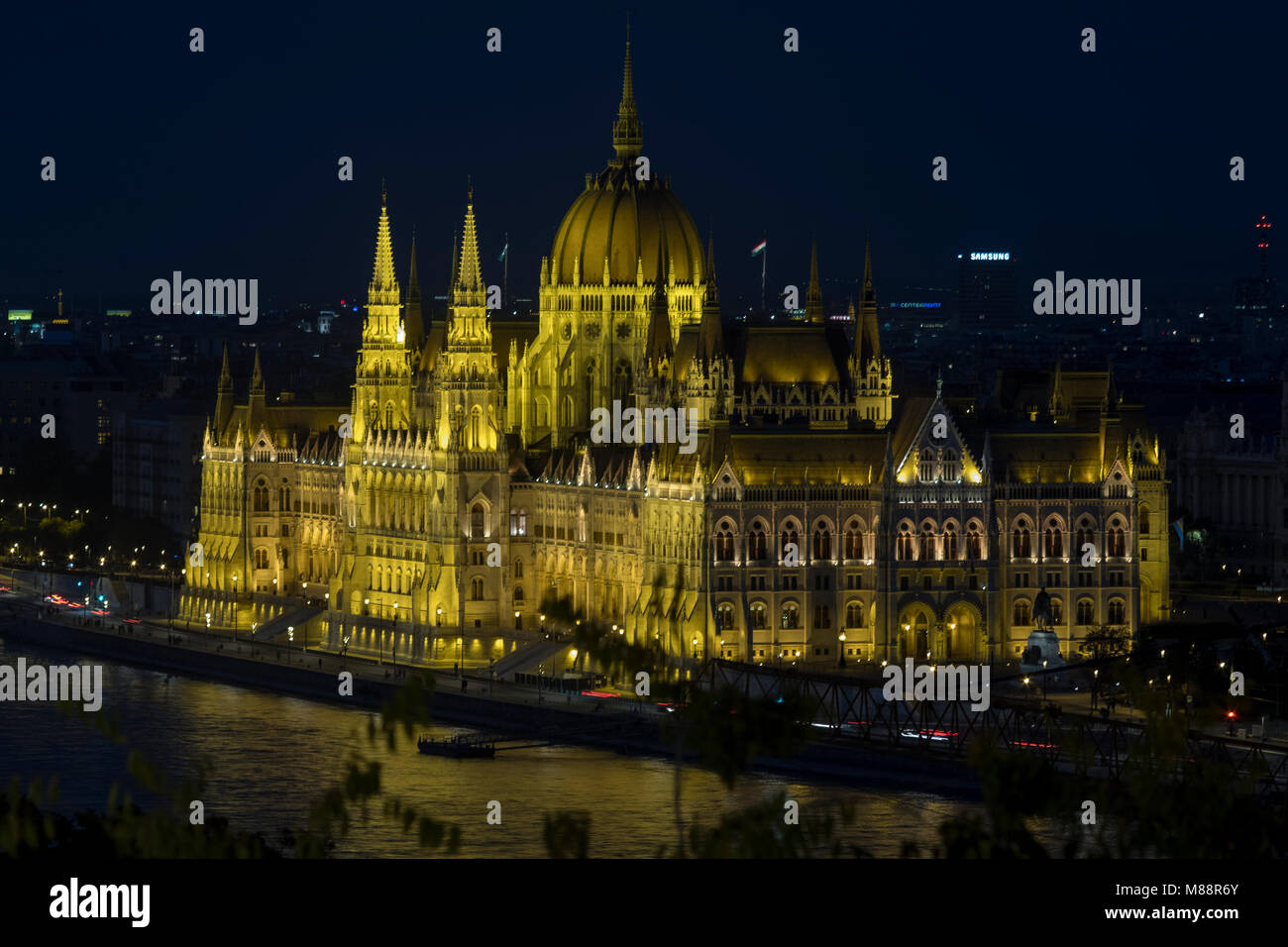 Static elevated telephoto shot clip of Hungarian Parliament at night in Budapest Stock Photo
