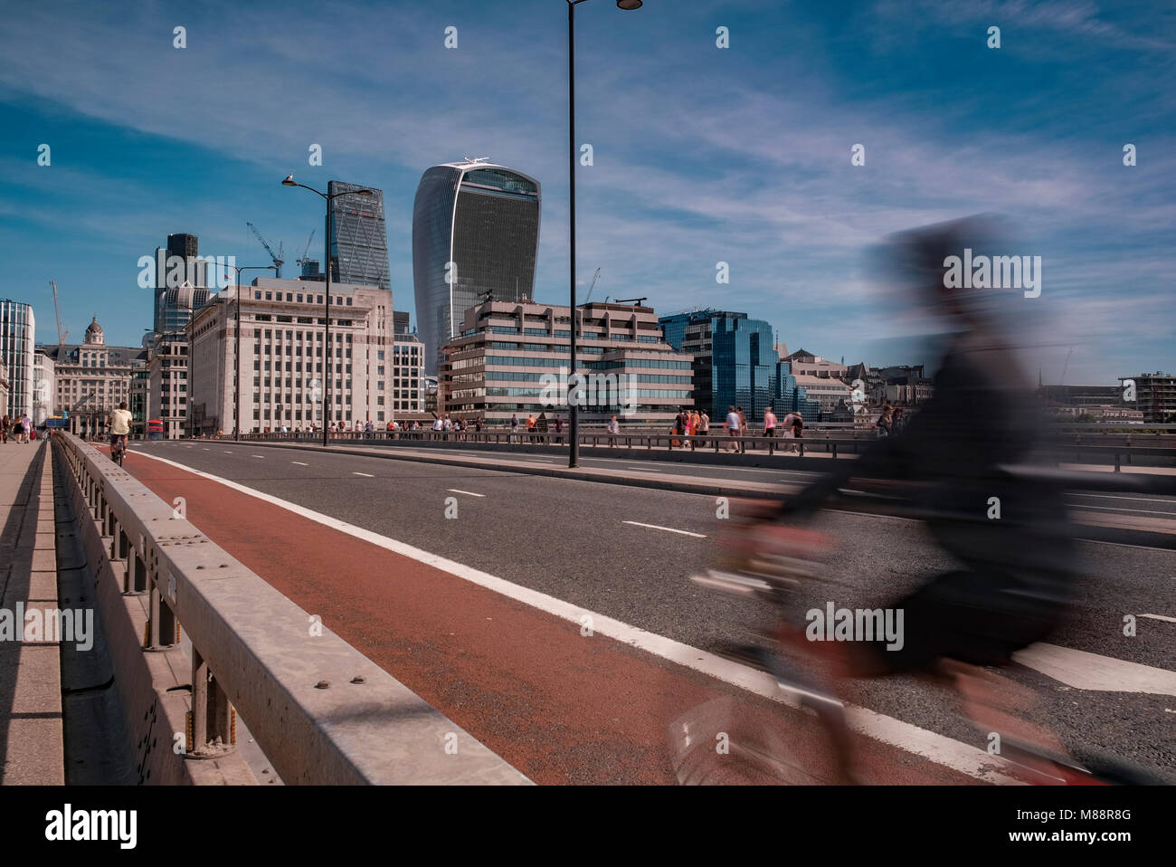 Motion of a cyclist as they speed across London Bridge towards The City on a Summers Morning Stock Photo