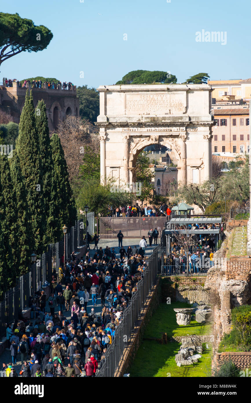 Tourists queuing to enter Palatine Hill and Roman Forum, with the Arch of Constantine to the rear. Elevated view from Colosseum, Rome, Italy. Stock Photo