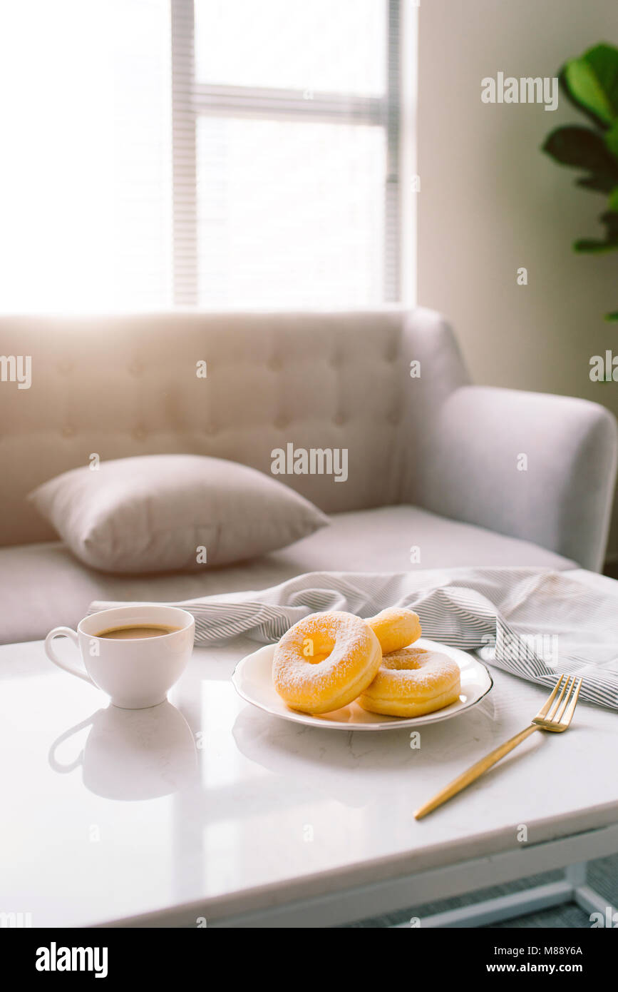 classic donut and coffee on white table Stock Photo - Alamy