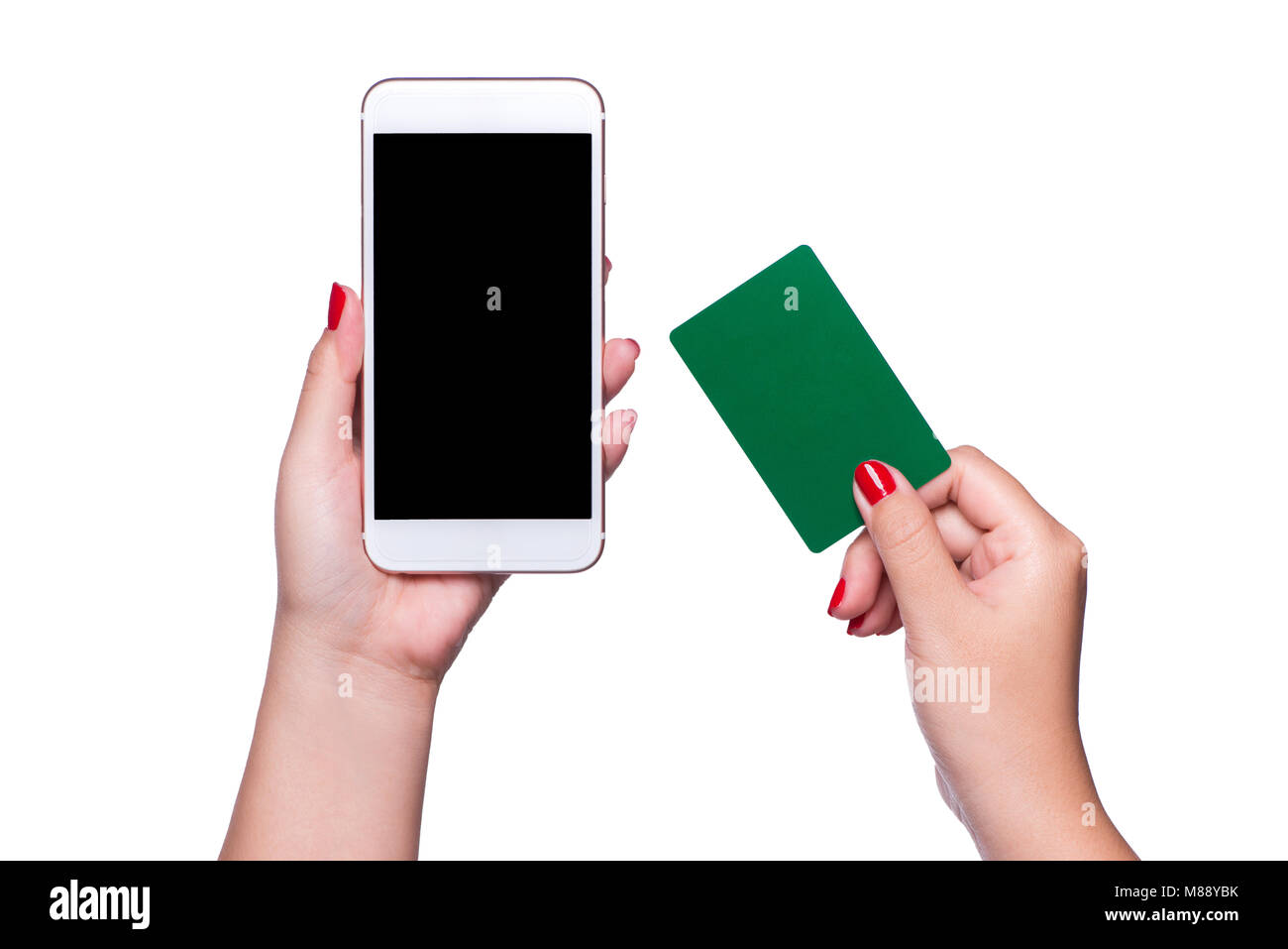 Female hands holding phone and credit card on isolated background Stock Photo