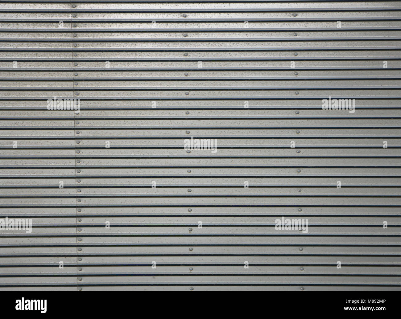 Corrugated metal wall, detail of a wall lined with metal, shiny steel