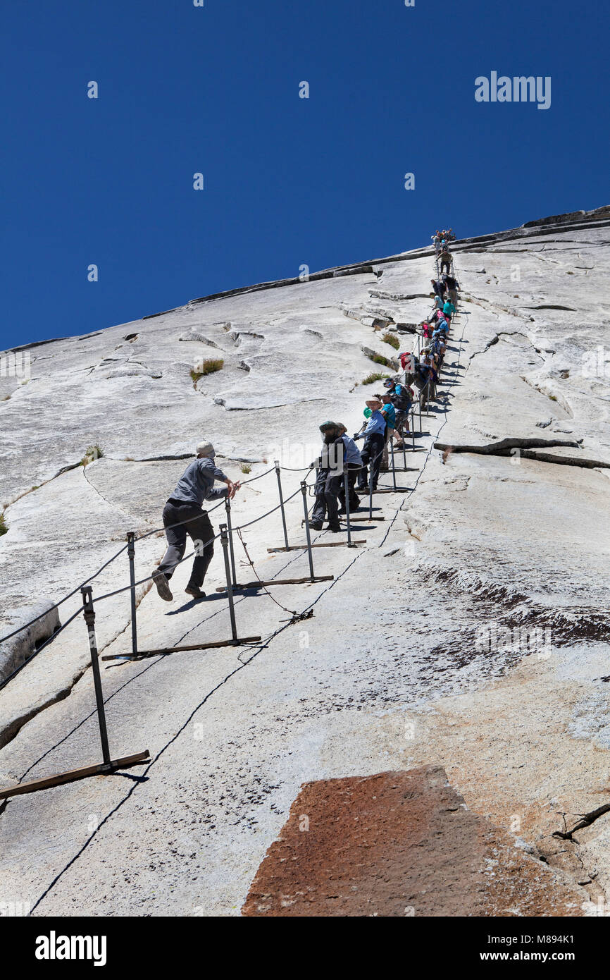 CA02882-00...CALIFORNIA - Hikers on the cable route up Half  Dome in Yosemite National Park. Stock Photo