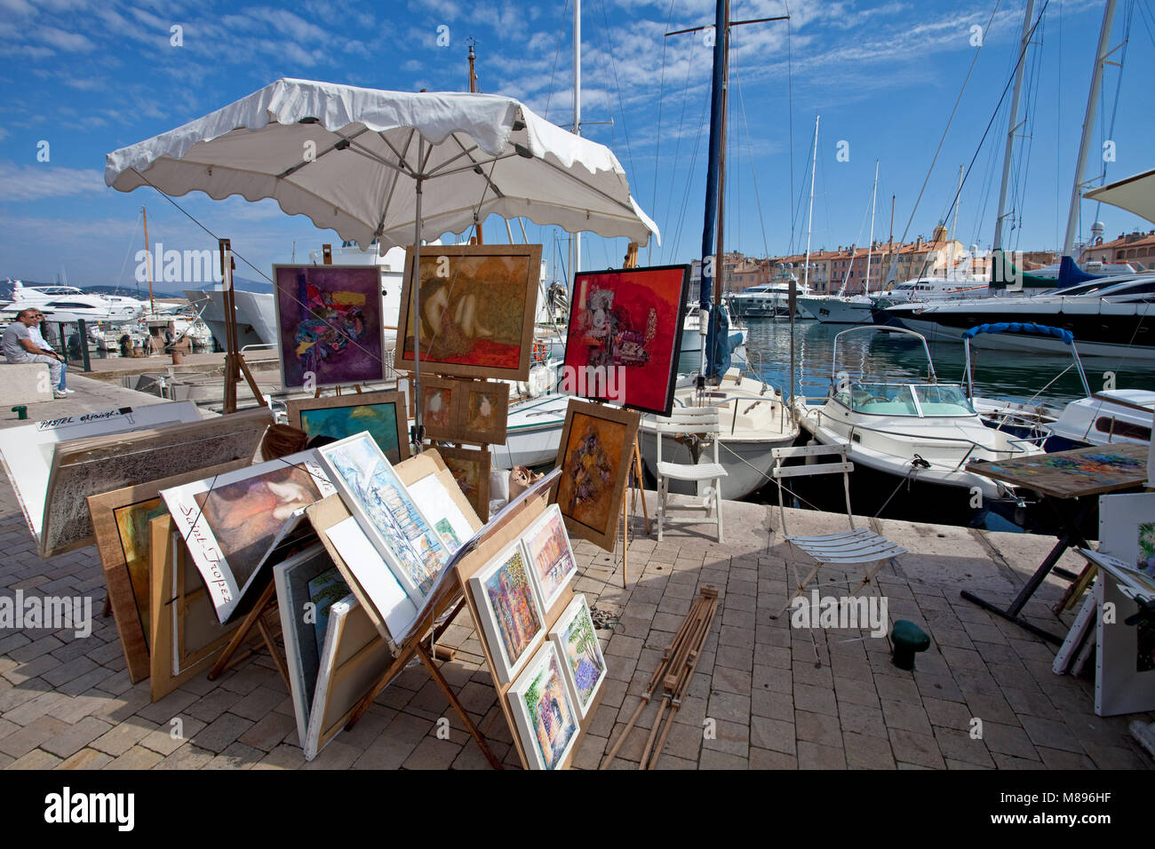 Paintings at strolling promenade at harbour of Saint-Tropez, french riviera, South France, Cote d'Azur, France, Europe Stock Photo