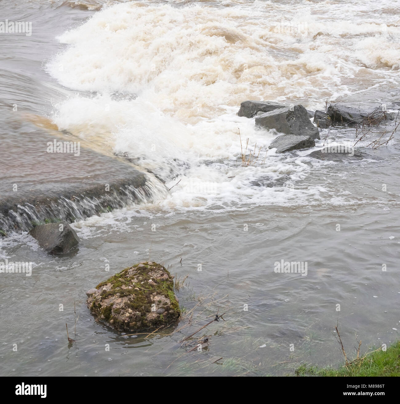 Flood water pouring in at Sawley Weir, Derbyshire, UK Stock Photo