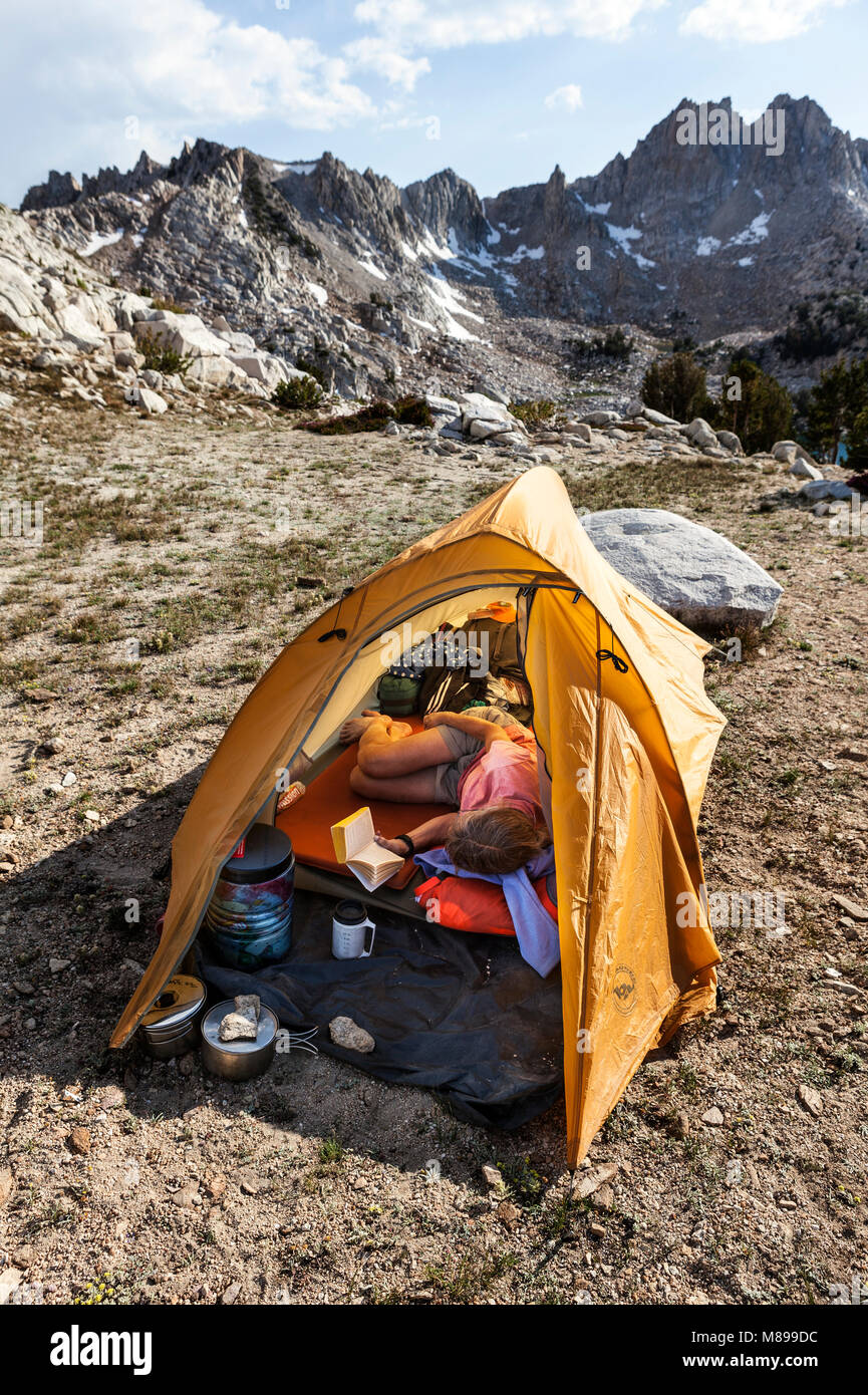 CA03291-00...CALIFORNIA - Vicky Spring relaxes at a campsite near Silver Pass in the John Muir Wilderness along the John Muir Trail (Pacific Crest Tra Stock Photo