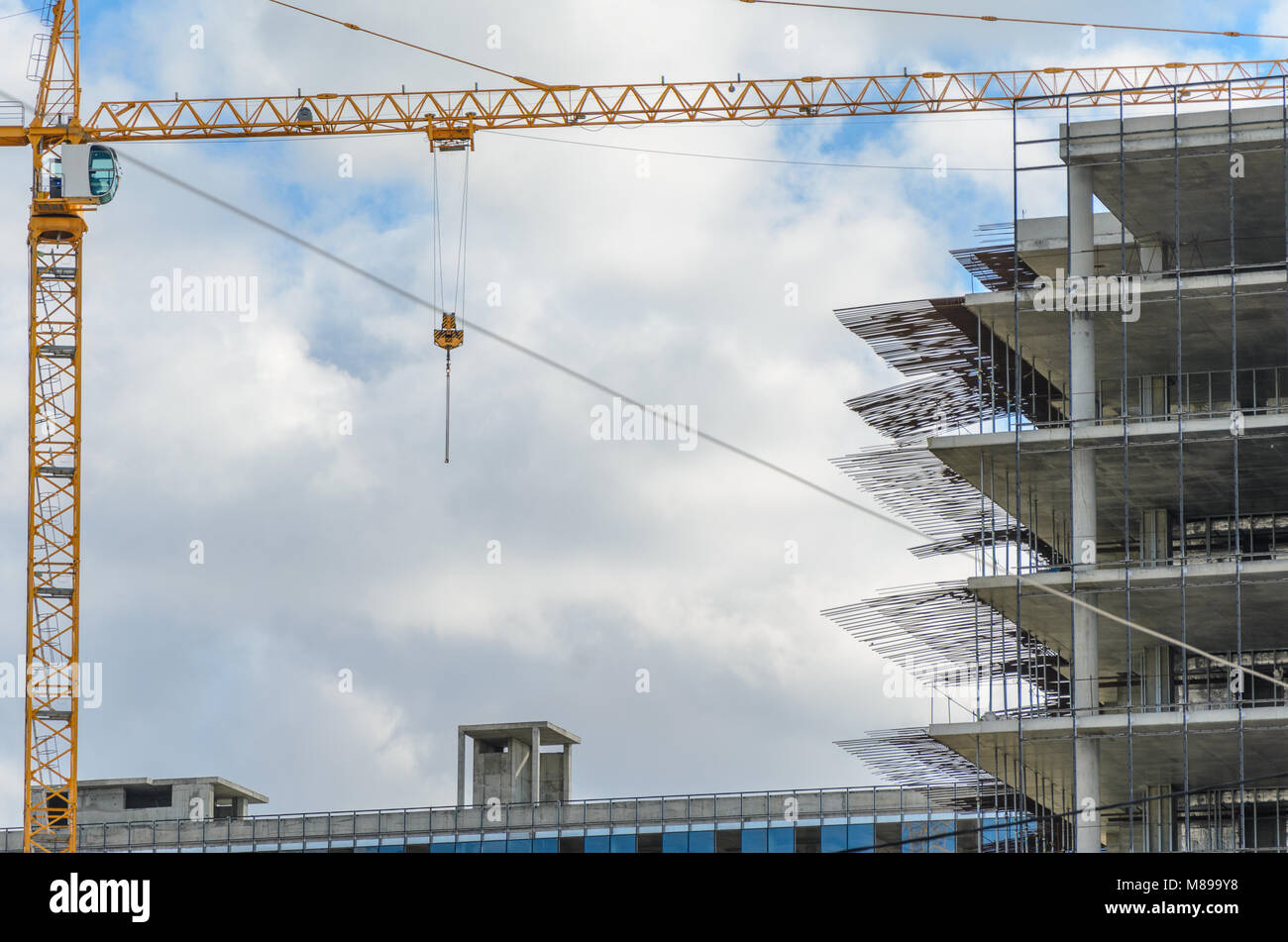 Construction site with crane and with unfinished skeleton of a high ...