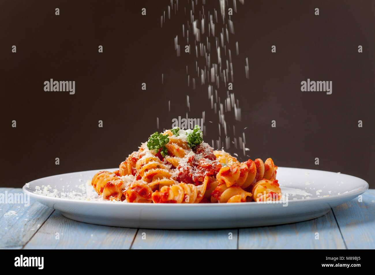 parmesan cheese falling on pasta Stock Photo Alamy
