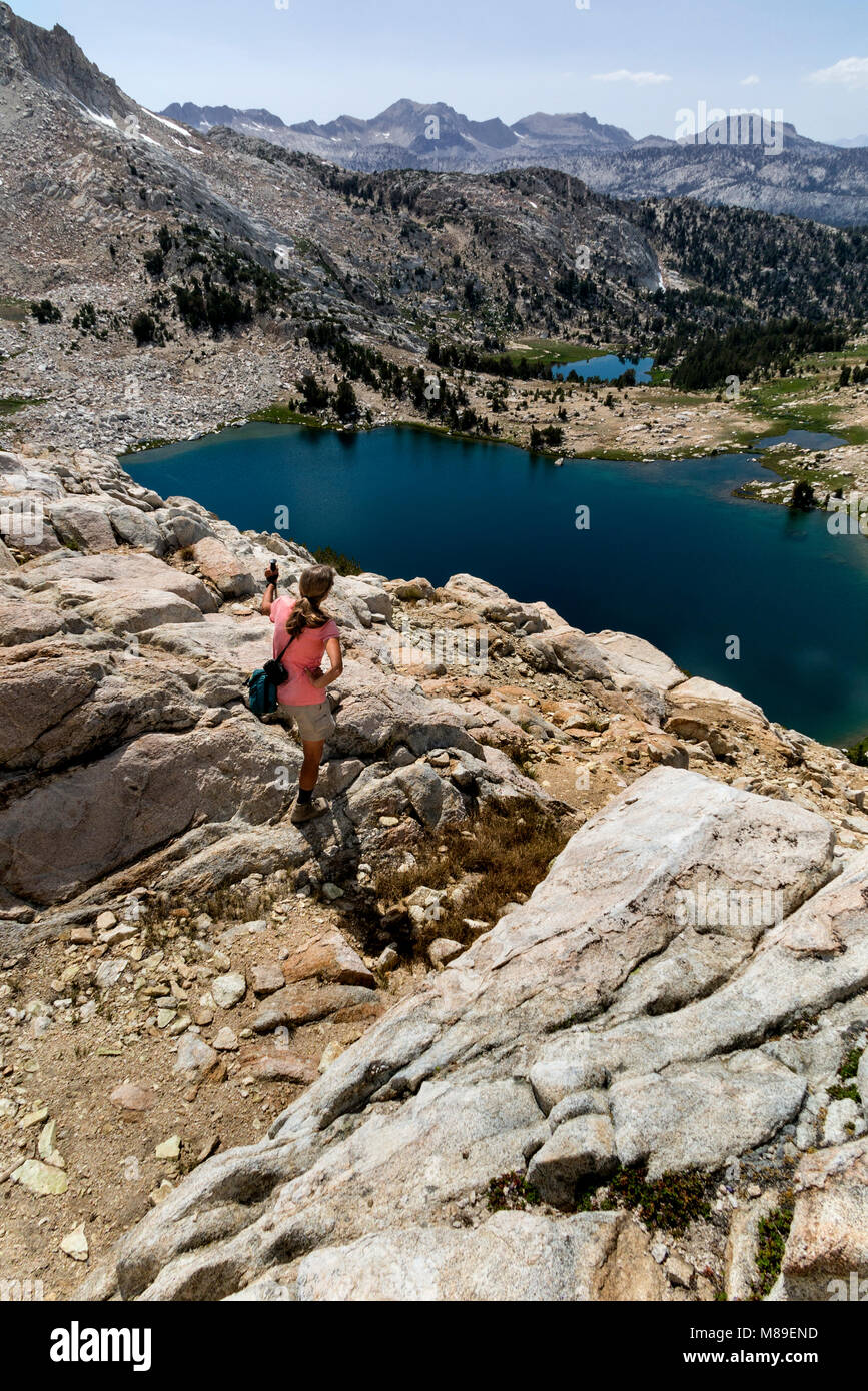 CA03364-00...CALIFORNIA - Vicky Spring taking in the view form Silver Pass along the John Muir Trail, John Muir Wilderness. Stock Photo