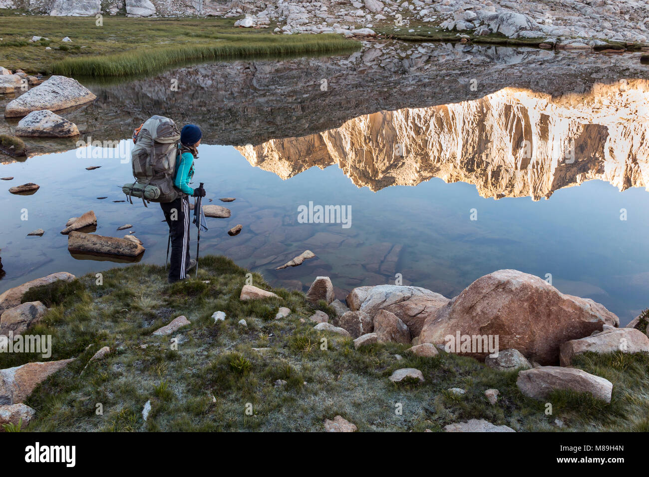 CA03413-00...CALIFORNIA - Vicky Spring stands next to a small tarn above Guitar Lake in Sequoia National Park.  (MR# S1) Stock Photo