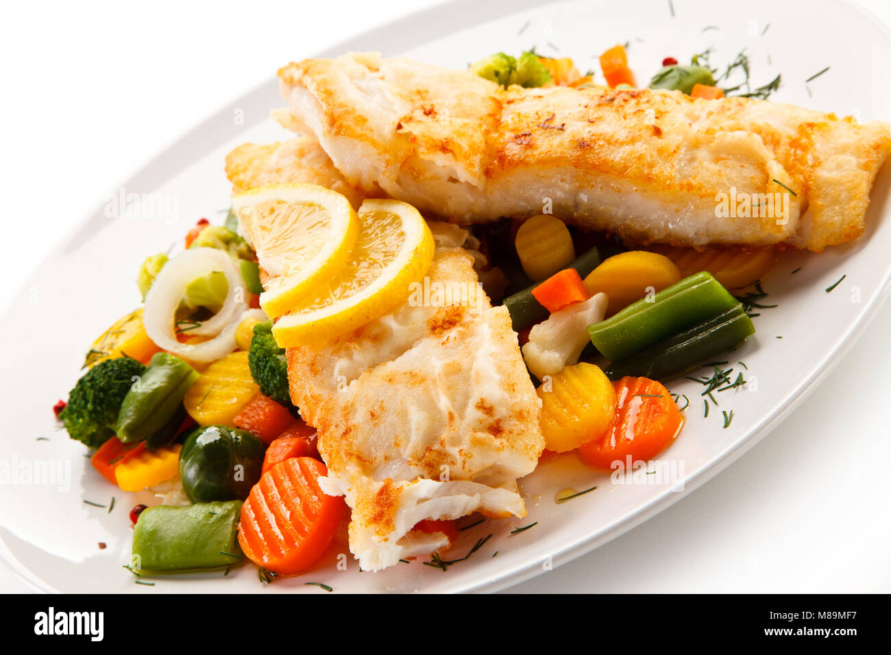 Fish dish - fried fish fillet and vegetables Stock Photo - Alamy