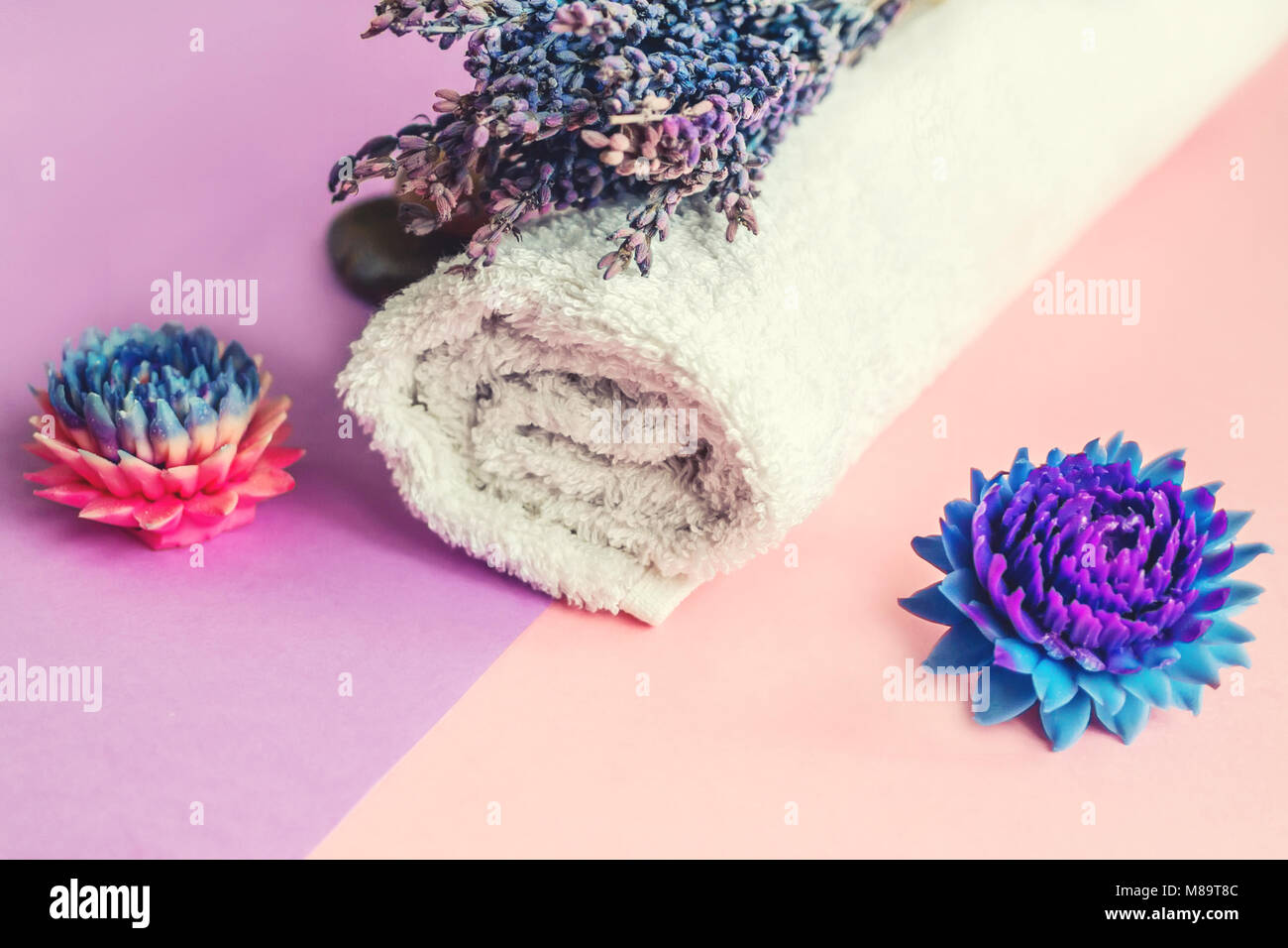 Beautiful soap in the form of flowers and towel with lavender flowers for Spa treatments on a two-tone background. Selective focus. The horizontal fra Stock Photo