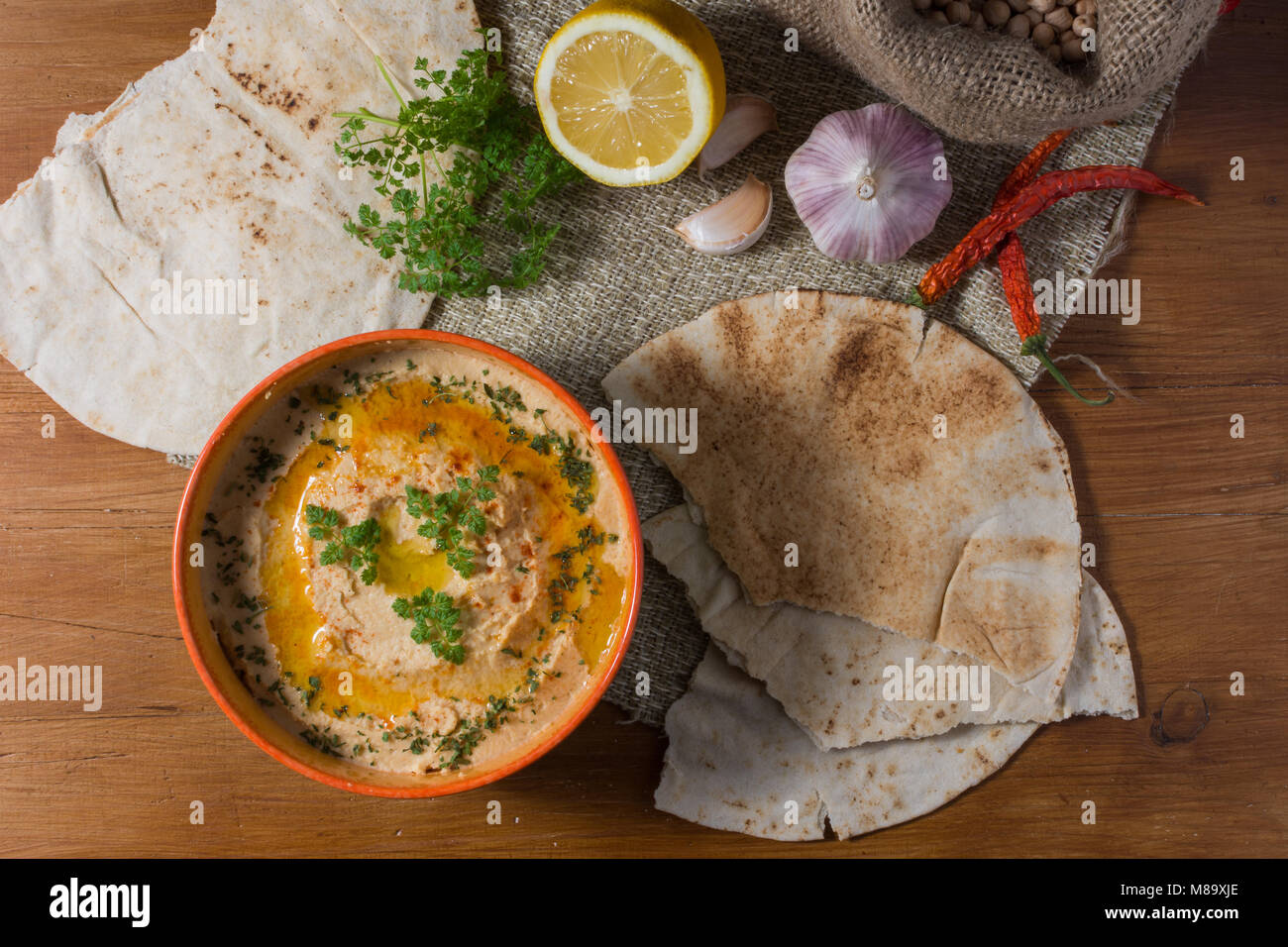 Traditional hummus salad on rustic wooden table Stock Photo - Alamy