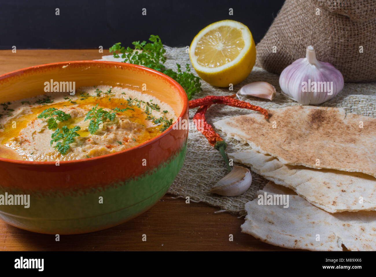 Traditional hummus salad on rustic wooden table Stock Photo - Alamy