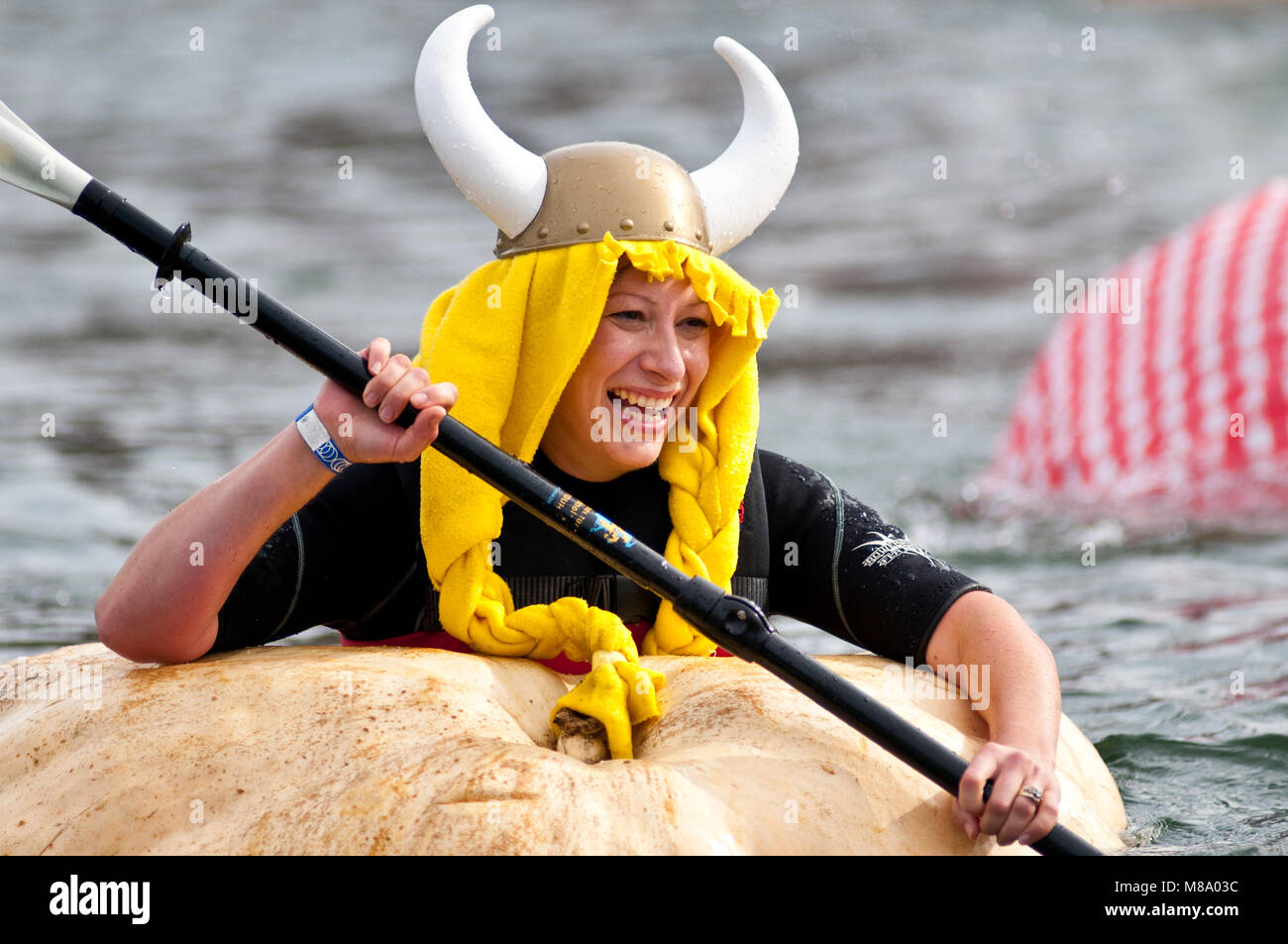 Cindy Tobeck - a giant pumpkin grower from Olympia, Washington - assumes the personna of 'Helga the Pumpkin Viking' as she paddles in her first giant  Stock Photo