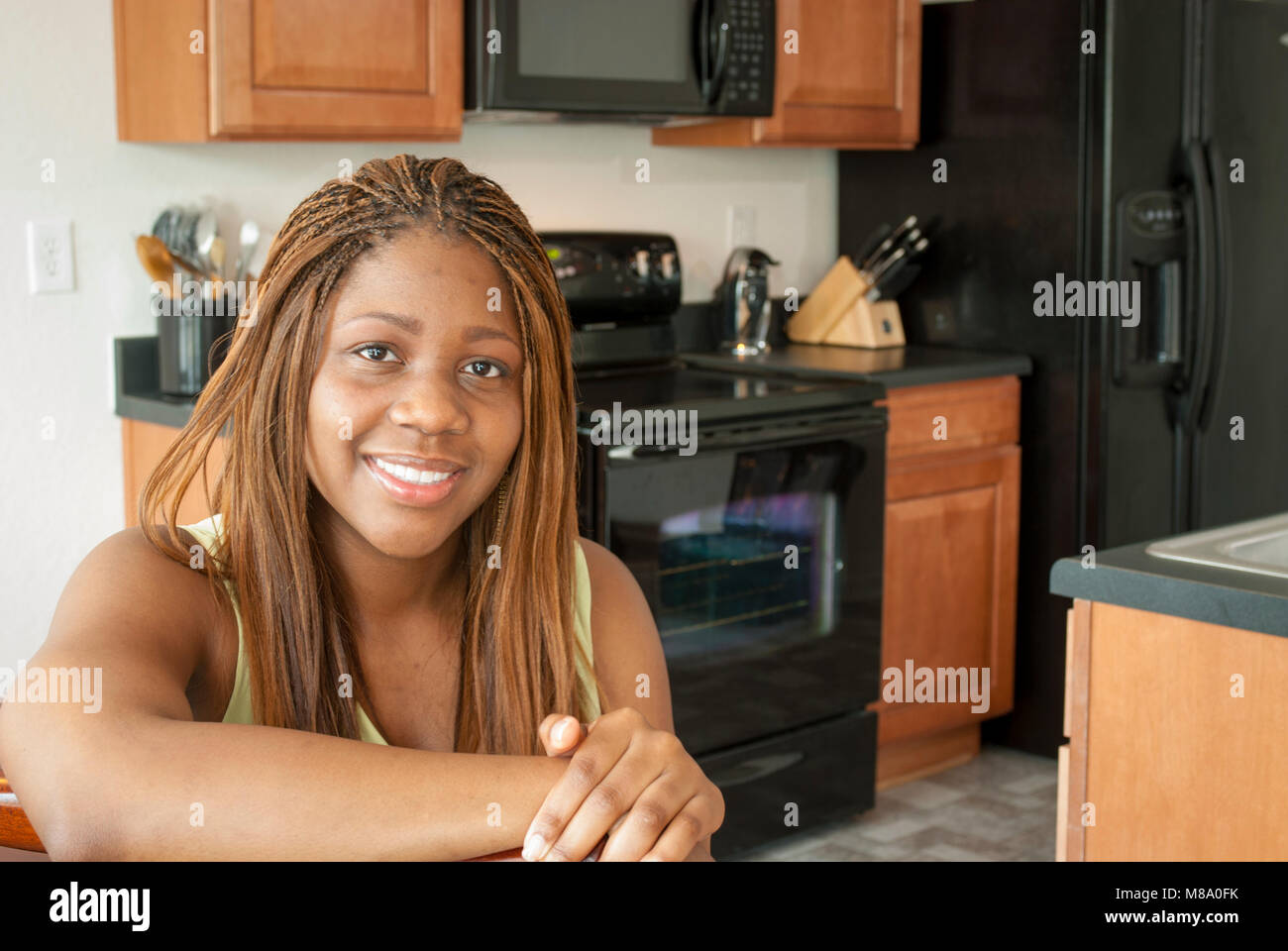 A young African American woman at her newly purchased home Stock Photo