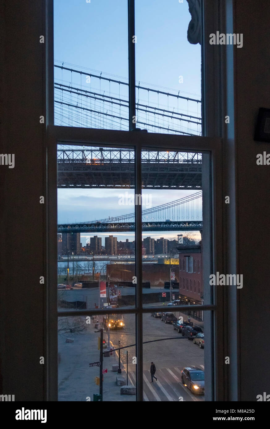 Parts of both Brooklyn Bridge and Manhattan Bridge is seen from a window in Dumbo, Brooklyn, NYC