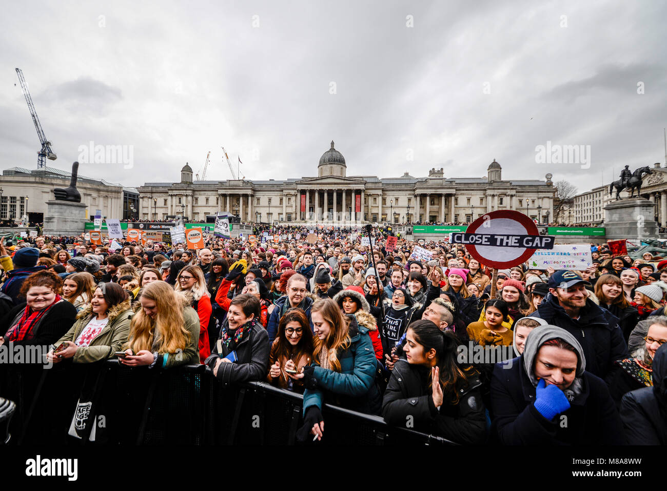 Crowds in Trafalgar Square watching speeches & performing at the March 4 Women women's equality protest organised by Care International in London Stock Photo