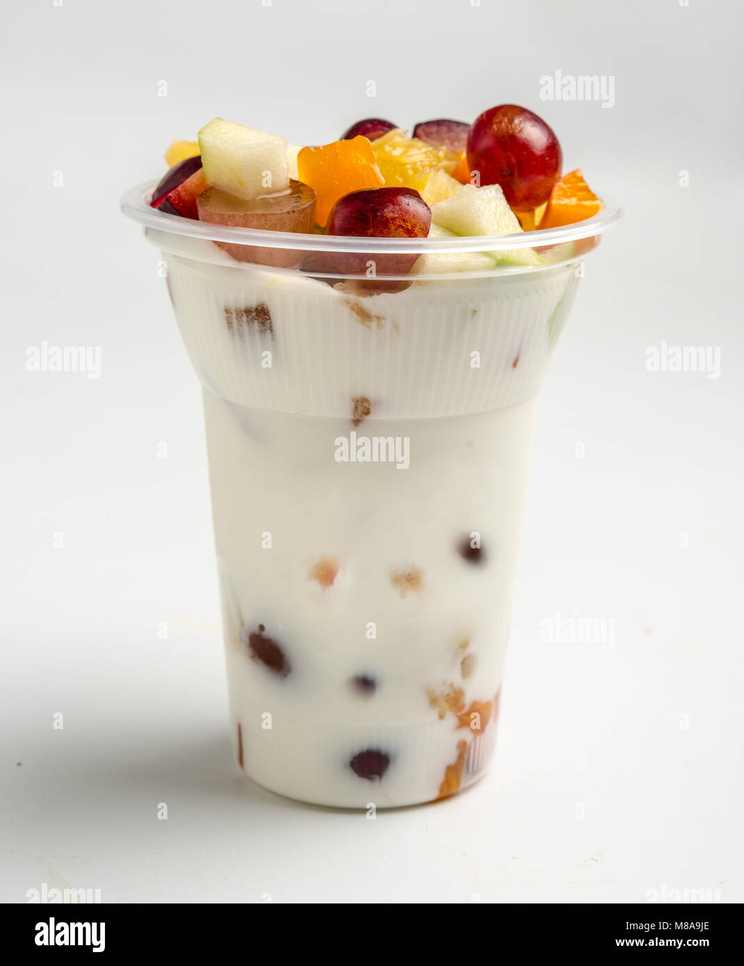 Fruit and yogurt in a plastic cup as a take away snack Stock Photo