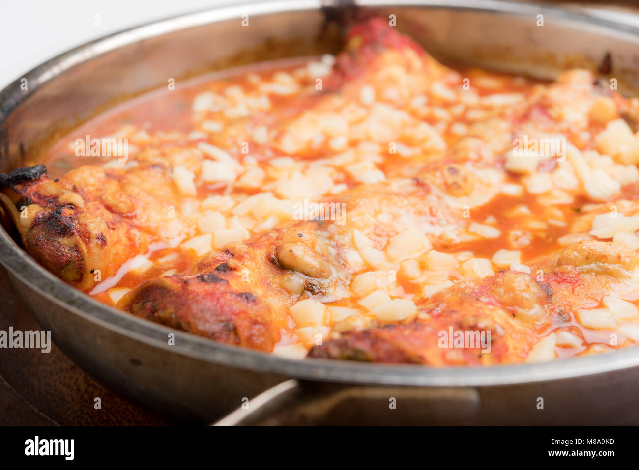 Italian cannelloni pasta baked in casserole dish Stock Photo