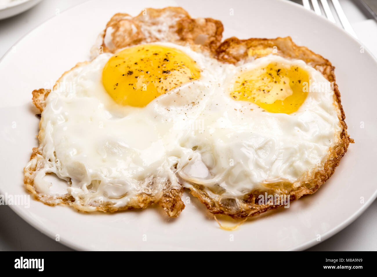 Traditional Israeli Breakfast with two fried eggs, yellow cheese, salad