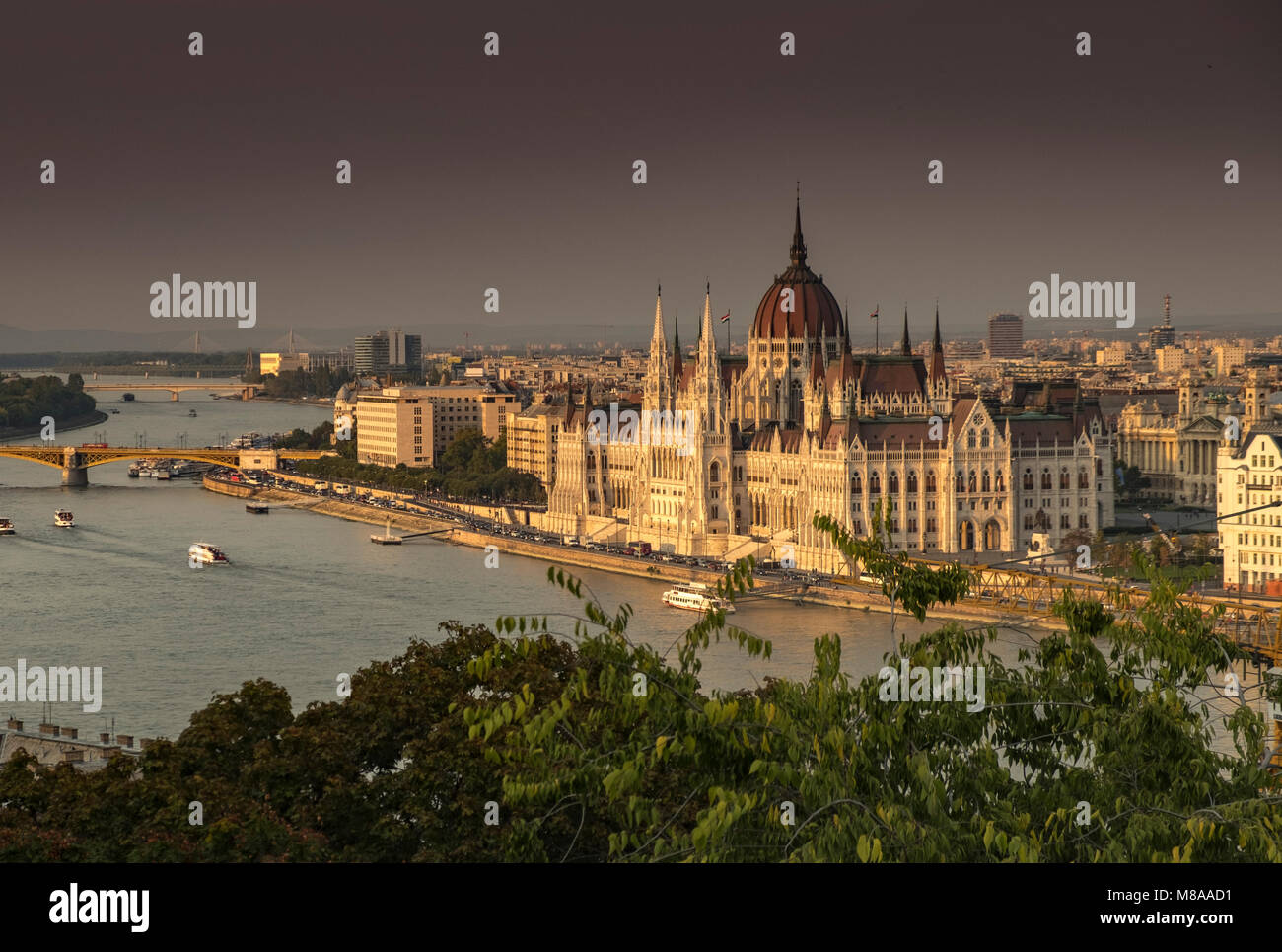 Wide shot of the River Danube and Hungarian parliament seen from Buda Castle. Many boats on river. Taken at dusk Stock Photo