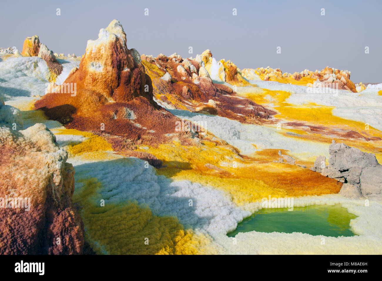 Yellow sulfuric volcanoes emitting toxic gas clouds, sulfur deposits white and green colors