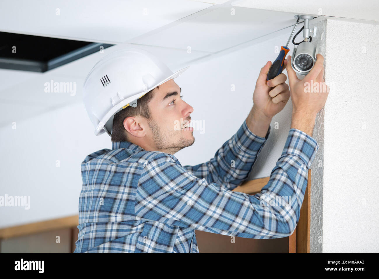 Contractor fitting security camera Stock Photo Alamy