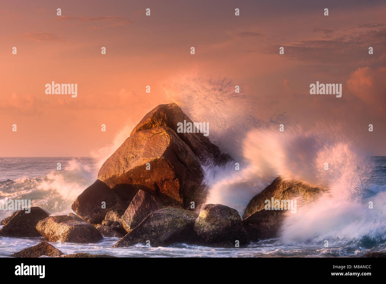 Tropical beach with rocks and big crashing waves Stock Photo - Alamy